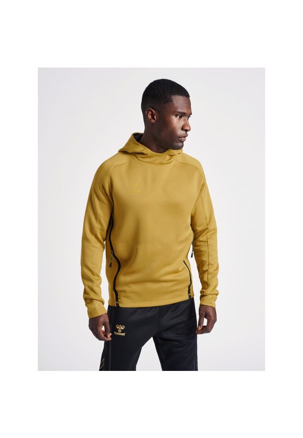 Bluza z kapturem Hummel Cima XK. Typ kołnierza: kaptur. Kolor: żółty, wielokolorowy, beżowy. Materiał: materiał. Wzór: nadruk. Sezon: zima