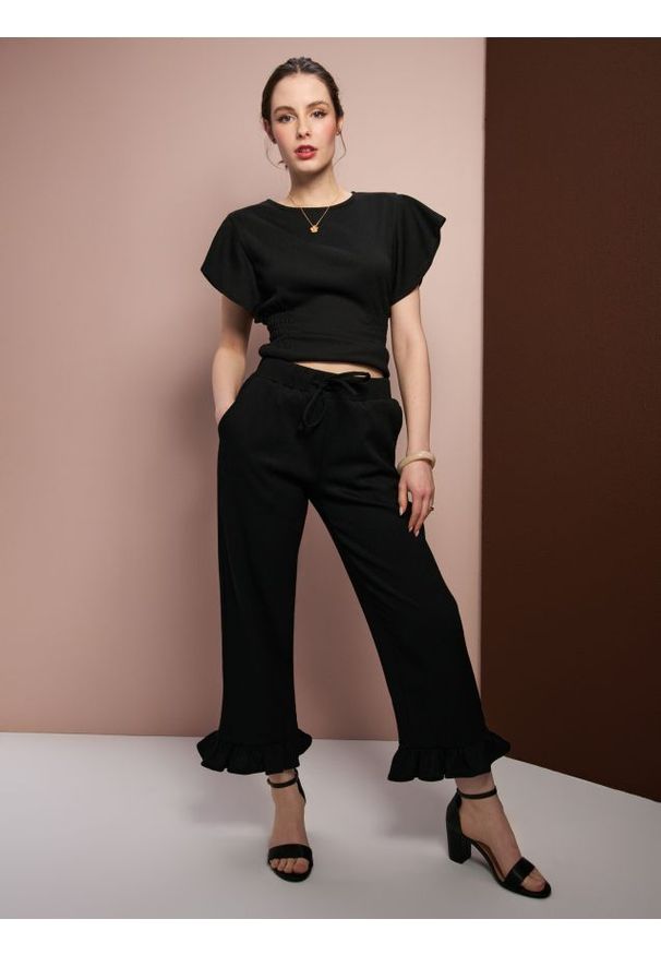 Sinsay - Spodnie loose z ozdobnymi falbanami - czarny. Kolor: czarny