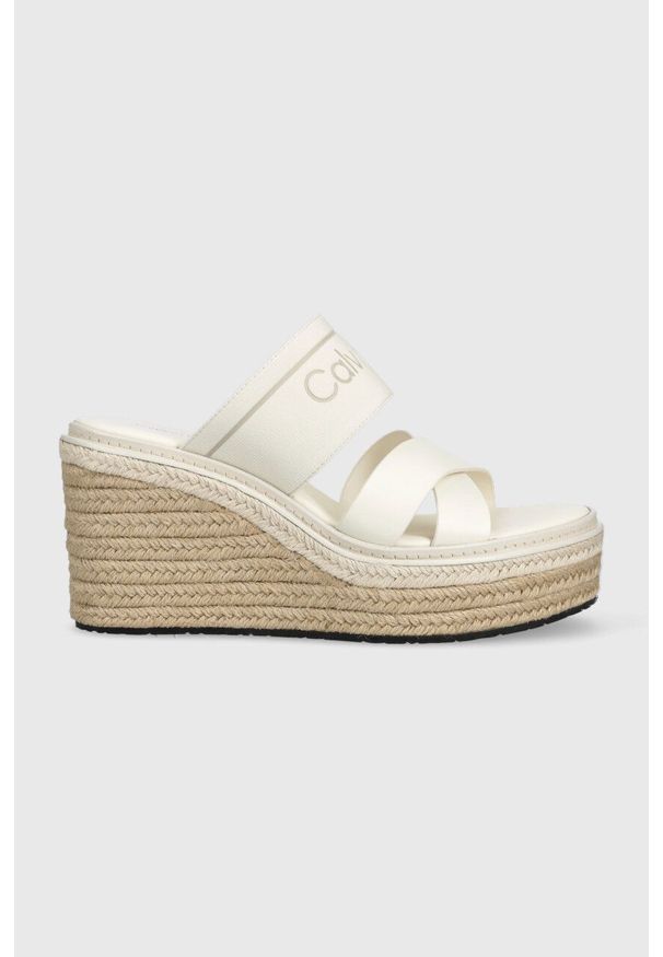 Calvin Klein klapki WEDGE 50HH - HE damskie kolor biały na koturnie HW0HW01498. Kolor: biały. Materiał: materiał, skóra, guma, włókno. Wzór: nadruk. Obcas: na koturnie