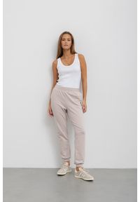 LEKKIE SPODNIE CELINE BEŻOWE XS - Flawless. Okazja: na co dzień. Kolor: beżowy. Materiał: guma, elastan, bawełna, dresówka, skóra. Styl: klasyczny, casual #1