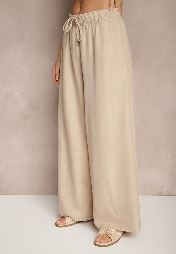 Renee - Beżowe Szerokie Spodnie High Waist Ozdobione Wiązaniem Telonia. Okazja: na co dzień. Stan: podwyższony. Kolor: beżowy. Wzór: aplikacja. Styl: casual, elegancki