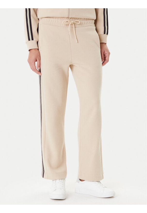 EA7 Emporio Armani Spodnie dresowe 7W000568 AF15528 U1046 Beżowy Relaxed Fit. Kolor: beżowy. Materiał: syntetyk