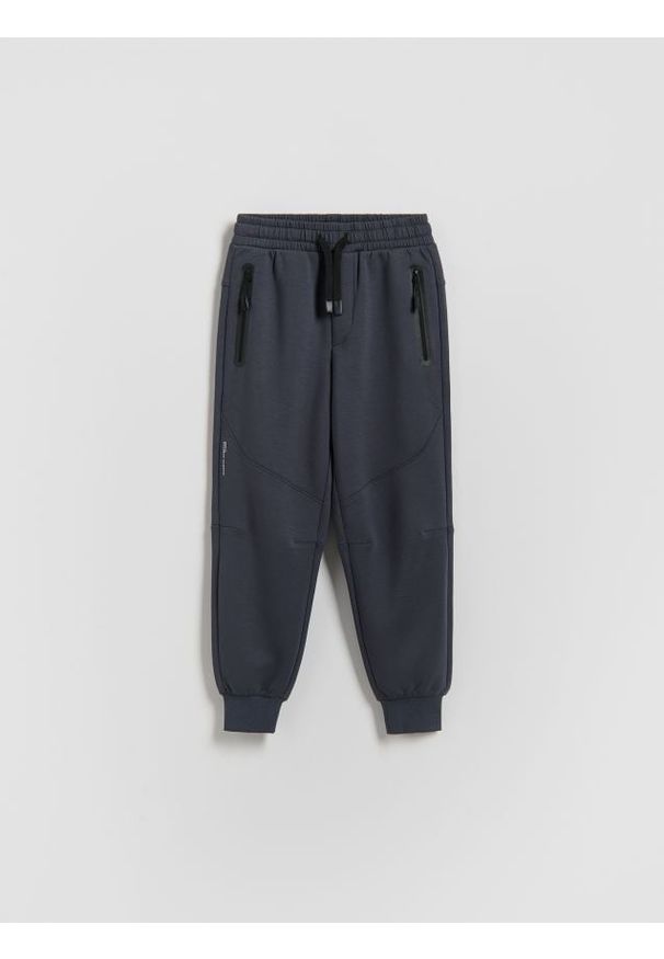 Reserved - Dzianinowe joggery - granatowy. Kolor: niebieski. Materiał: dzianina