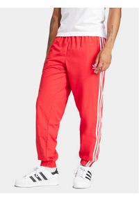 Adidas - adidas Spodnie dresowe Adicolor Woven Firebird IT2498 Czerwony Regular Fit. Kolor: czerwony. Materiał: syntetyk