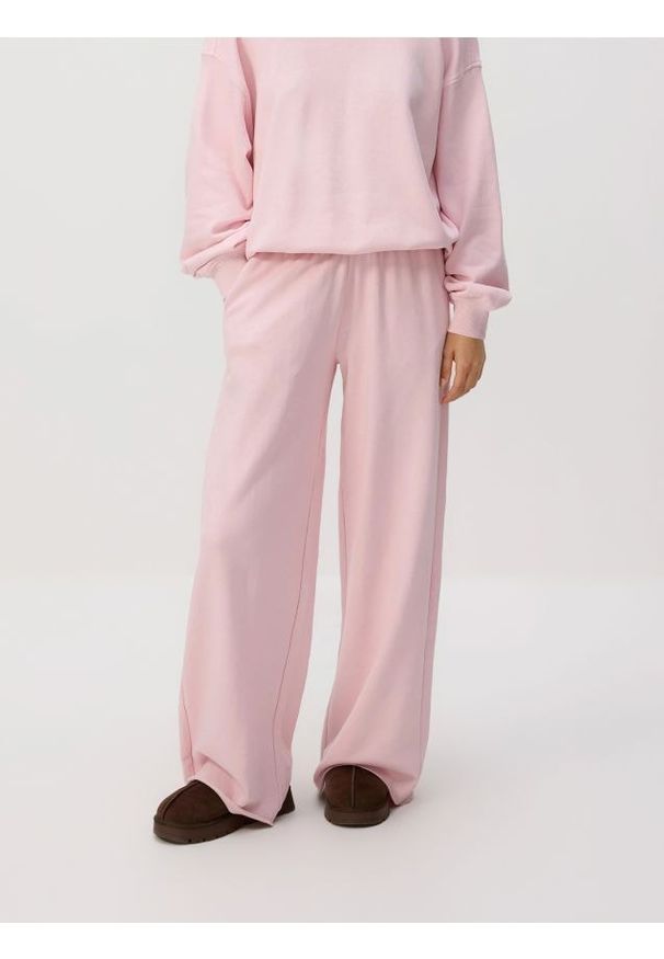 Reserved - Spodnie dresowe z szerokimi nogawkami - pastelowy róż. Kolor: różowy. Materiał: dresówka