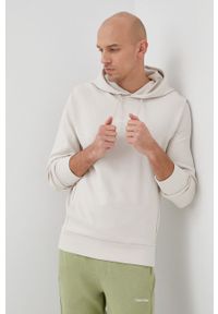 Calvin Klein bluza męska kolor beżowy z kapturem gładka. Typ kołnierza: kaptur. Kolor: beżowy. Wzór: gładki