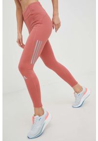 adidas Performance legginsy do biegania Own the Run Winter damskie kolor pomarańczowy z nadrukiem. Kolor: pomarańczowy. Materiał: skóra, materiał. Wzór: nadruk. Sport: bieganie #1