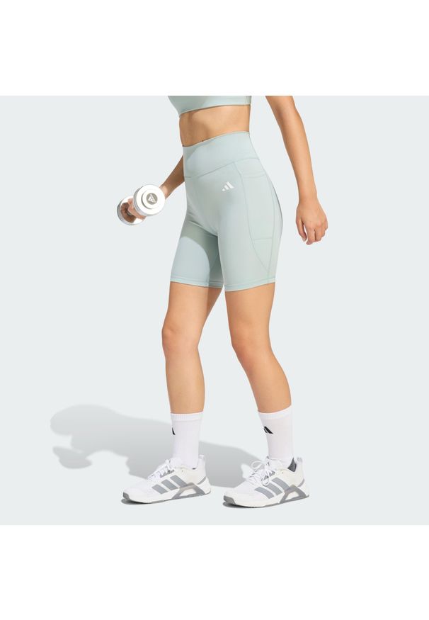 Adidas - Krótkie legginsy Optimé Essentials Stash Pocket 7-Inch. Stan: podwyższony. Kolor: zielony. Długość: krótkie. Sport: fitness