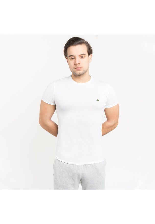 Koszulka męska Lacoste (TH2038-001). Typ kołnierza: polo. Kolor: biały. Materiał: dzianina. Długość: krótkie. Sezon: lato. Sport: bieganie