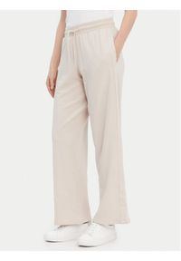 TOMMY HILFIGER - Tommy Hilfiger Spodnie dresowe UW0UW04771 Beżowy Relaxed Fit. Kolor: beżowy. Materiał: dresówka #1