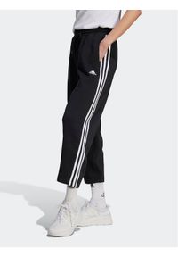 Adidas - adidas Spodnie dresowe Essentials 3-Stripes Open Hem Fleece HZ5748 Czarny Loose Fit. Kolor: czarny. Materiał: bawełna