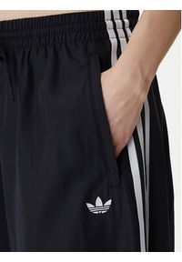 Adidas - adidas Spodnie dresowe Firebird Adilenium KD2914 Czarny Regular Fit. Kolor: czarny. Materiał: syntetyk #2