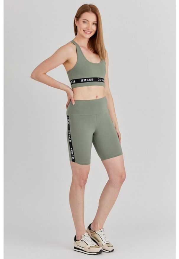 Guess - GUESS Zielone krótkie legginsy damskie z lampasami, Rozmiar S. Kolor: zielony. Materiał: bawełna. Długość: krótkie