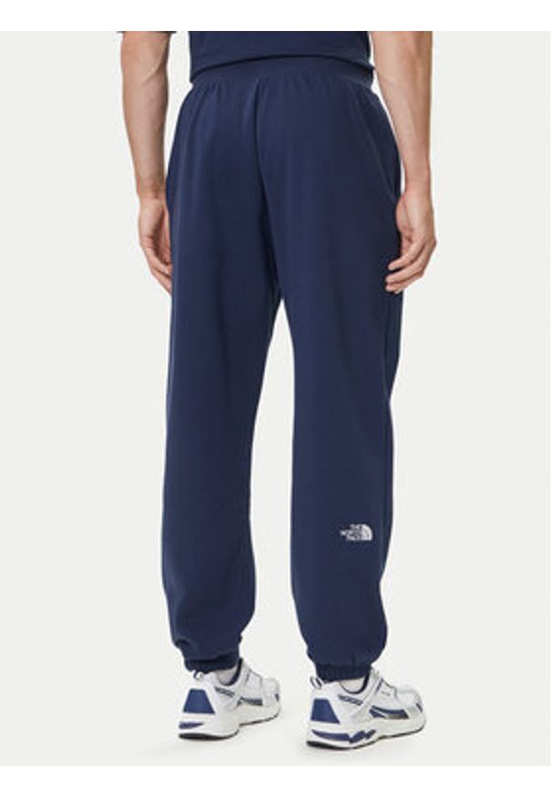 The North Face Spodnie dresowe Essential NF0A8C1F Granatowy Relaxed Fit. Kolor: niebieski. Materiał: syntetyk