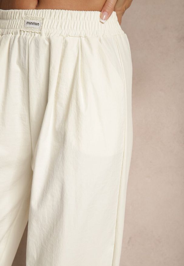 Renee - Jasnobeżowe Spodnie o Szerokim Kroju z Bawełną High Waist Ozdobione Naszywką Naneriela. Okazja: na co dzień. Stan: podwyższony. Kolor: beżowy. Materiał: bawełna. Wzór: aplikacja. Styl: casual, elegancki