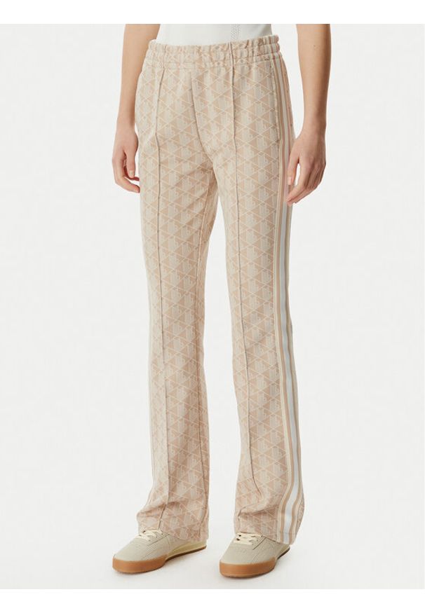 Lacoste Spodnie dresowe XF9313 Beżowy jasny Regular Fit. Kolor: beżowy. Materiał: syntetyk