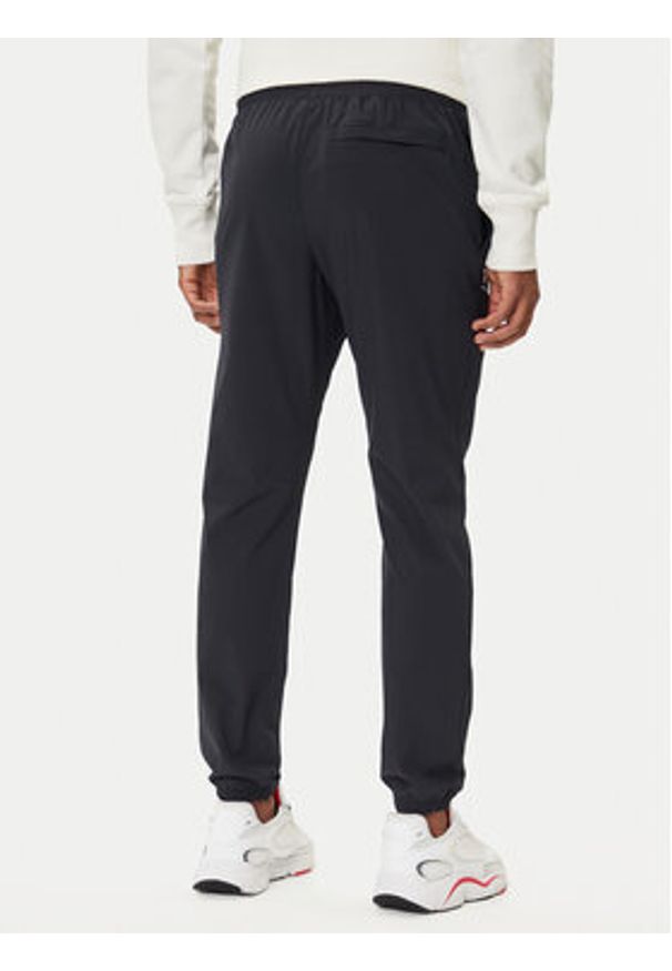 Under Armour Spodnie dresowe UA Vibe Woven 1386557 Czarny Regular Fit. Kolor: czarny. Materiał: syntetyk