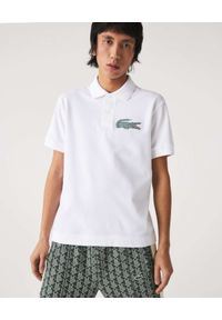 Lacoste - LACOSTE - Biała koszulka polo z logo Regular Fit. Typ kołnierza: polo. Kolor: biały. Materiał: prążkowany, bawełna. Wzór: haft, aplikacja. Styl: klasyczny