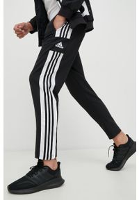 adidas Performance spodnie męskie kolor czarny gładkie. Kolor: czarny. Materiał: tkanina, poliester, skóra, materiał. Wzór: gładki. Sport: fitness #1