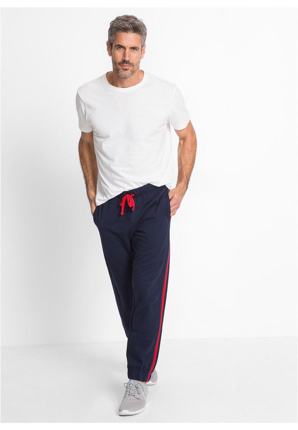 bonprix - Spodnie sportowe z kontrastowymi elementami. Kolor: niebieski. Materiał: dresówka. Styl: sportowy