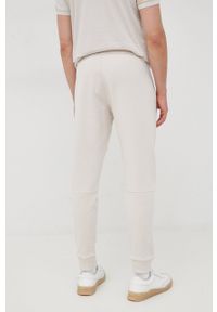Calvin Klein spodnie męskie kolor beżowy gładkie. Kolor: beżowy. Wzór: gładki #2