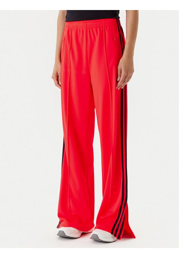 Adidas - adidas Spodnie dresowe adicolor Classic Firebird JW1227 Pomarańczowy Loose Fit. Kolor: pomarańczowy. Materiał: syntetyk
