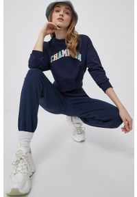 Champion spodnie 217404 kolor granatowy z aplikacją. Kolor: niebieski. Materiał: włókno, dzianina, materiał. Wzór: aplikacja #7