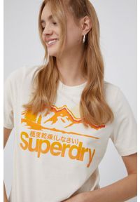 Superdry T-shirt damski kolor kremowy. Okazja: na co dzień. Kolor: beżowy. Wzór: nadruk. Styl: casual