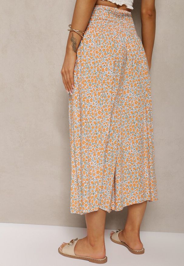 Renee - Pomarańczowo-Niebieskie Bawełniane Spodnie z Szerokimi Nogawkami 7/8 w Kwiatki Aliany. Kolor: pomarańczowy. Materiał: bawełna. Wzór: kwiaty