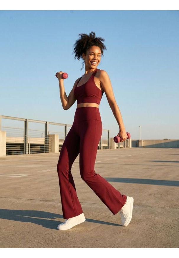Sinsay - Spodnie flare Gym Hard - bordowy. Kolor: czerwony