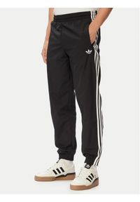 Adidas - adidas Spodnie dresowe Firebird Woven KE1371 Czarny Regular Fit. Kolor: czarny. Materiał: syntetyk #1