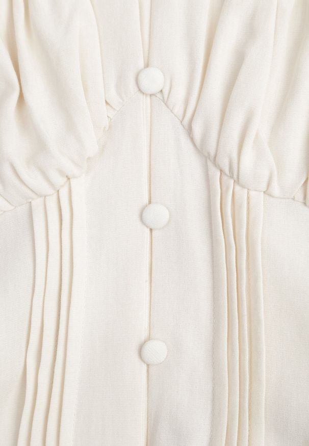 Renee - Jasnobeżowa Gorsetowa Sukienka Hiszpanka Vices z Guzikami i Bufiastymi Rękawami Resena. Typ kołnierza: dekolt gorset, dekolt hiszpanka. Kolor: beżowy. Materiał: bawełna, skóra. Typ sukienki: gorsetowe