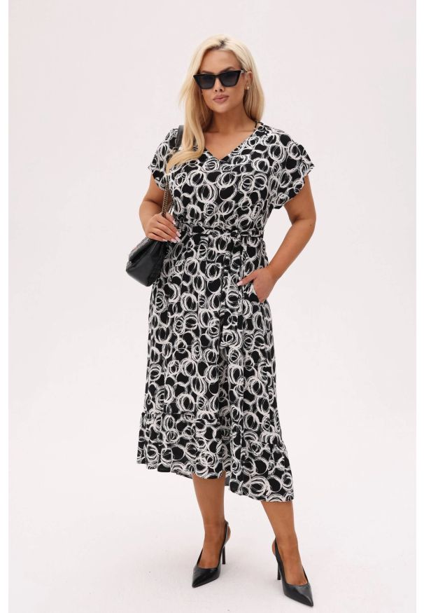 Moda Size Plus Iwanek - Asymetryczna sukienka Kiara MIDI z wiązaniem i falbanką - Black Ink PLUS SIZE XXL OVERSIZE. Okazja: na co dzień. Typ kołnierza: dekolt kopertowy, dekolt w kształcie V. Kolekcja: plus size. Materiał: wiskoza, tkanina, materiał. Długość rękawa: krótki rękaw. Typ sukienki: oversize, dla puszystych, asymetryczne. Styl: casual, elegancki. Długość: midi