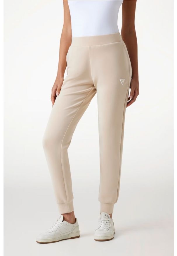 Guess - GUESS Spodnie damskie dresowe w kolorze taupe Olympe, Rozmiar L. Kolor: beżowy. Materiał: dresówka