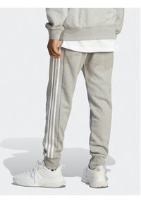 Adidas - adidas Spodnie dresowe Essentials French Terry Tapered Cuff 3-Stripes Joggers IC9407 Szary Regular Fit. Kolor: szary. Materiał: dresówka, bawełna
