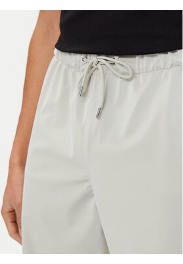 Rains Spodnie przeciwdeszczowe Unisex 18560 Beżowy Regular Fit. Kolor: beżowy. Materiał: syntetyk