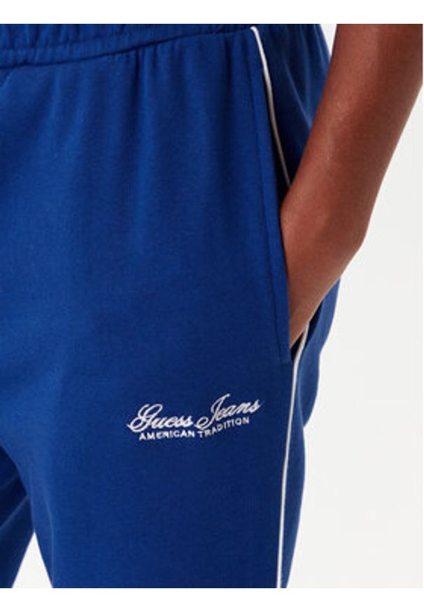 Guess Jeans Spodnie dresowe W5YB32 K68I4 Niebieski Regular Fit. Kolor: niebieski. Materiał: bawełna