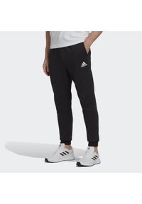 Adidas - Essentials Fleece Regular Tapered Pants. Kolor: czarny, biały, wielokolorowy. Materiał: materiał. Sport: fitness #1
