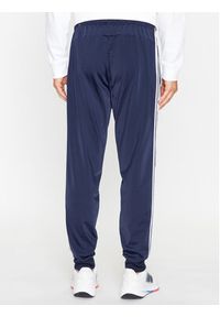 Adidas - adidas Spodnie dresowe Essentials Warm-Up 3-Stripes H46106 Granatowy Regular Fit. Kolor: niebieski. Materiał: syntetyk, dresówka