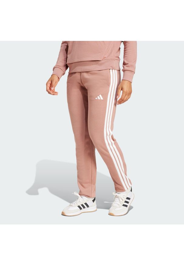 Adidas - Spodnie Essentials 3-Stripes French Terry Cuffed. Kolor: różowy, biały, wielokolorowy. Materiał: materiał. Sport: fitness