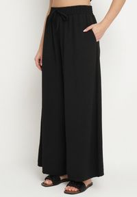 Born2be - Czarne Szerokie Spodnie Typu Palazzo z Wiązaniem Ulialitia. Okazja: na co dzień. Stan: podwyższony. Kolor: czarny. Styl: elegancki, casual