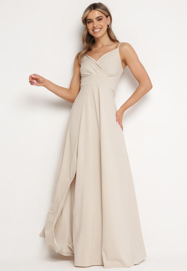 Born2be - Beżowa Rozkloszowana Klasyczna Sukienka z Kopertowym Dekoltem na Cienkich Ramiączkach z Rozcięciem Vinelia. Typ kołnierza: dekolt kopertowy. Kolekcja: dla wysokich. Kolor: beżowy. Długość rękawa: na ramiączkach. Typ sukienki: kopertowe. Styl: klasyczny. Długość: maxi