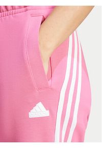 Adidas - adidas Spodnie dresowe Future Icons 3-Stripes IS3942 Różowy Regular Fit. Kolor: różowy. Materiał: bawełna