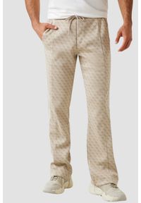 Guess - GUESS Beżowe męskie spodnie dresowe z lampasami w zielony monogram Parimo 4G, Rozmiar XXL. Kolor: beżowy. Materiał: dresówka #1