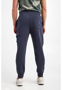 Armani Exchange - Spodnie dresowe ARMANI EXCHANGE. Materiał: dresówka. Wzór: aplikacja