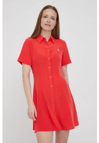 Calvin Klein Jeans sukienka kolor czerwony mini rozkloszowana. Kolor: czerwony. Materiał: tkanina. Długość rękawa: krótki rękaw. Typ sukienki: rozkloszowane. Długość: mini