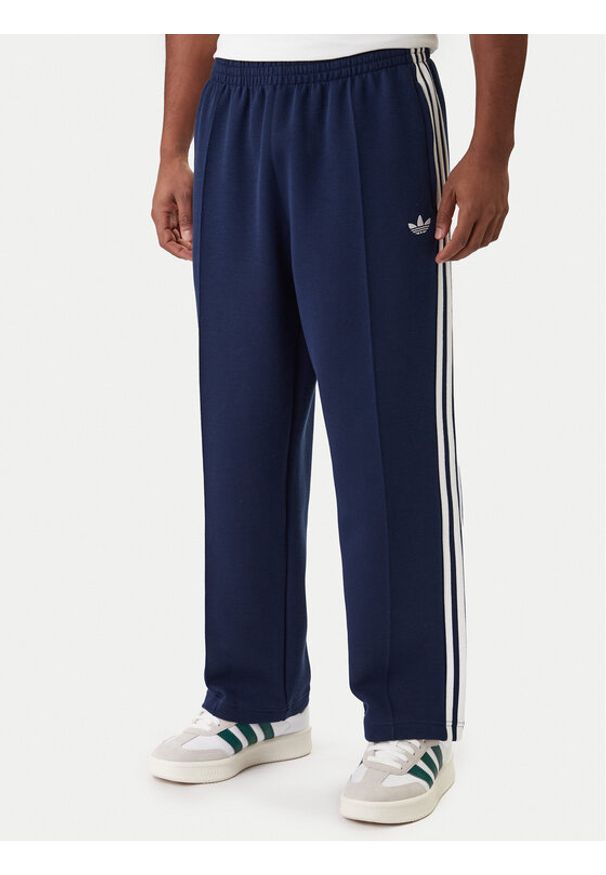 Adidas - adidas Spodnie dresowe adicolor Spacer Track KD4087 Granatowy Baggy Fit. Kolor: niebieski. Materiał: syntetyk. Sport: turystyka piesza