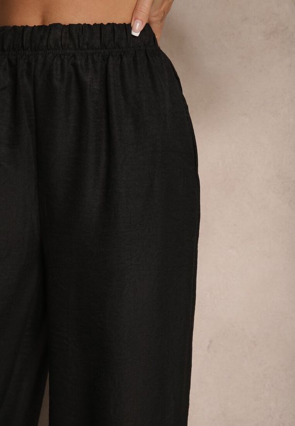 Renee - Czarne Spodnie Typu Palazzo High Waist o Szerokim Kroju Arathira. Okazja: na co dzień, na imprezę. Stan: podwyższony. Kolor: czarny. Materiał: jedwab. Długość: długie. Styl: elegancki, casual