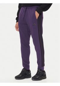 Adidas - adidas Spodnie dresowe Essentials 3-Stripes JX0750 Fioletowy Regular Fit. Kolor: fioletowy. Materiał: bawełna