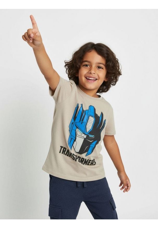 Sinsay - Bawełniana koszulka z nadrukiem Transformers - kremowy. Kolor: kremowy. Materiał: bawełna. Wzór: nadruk